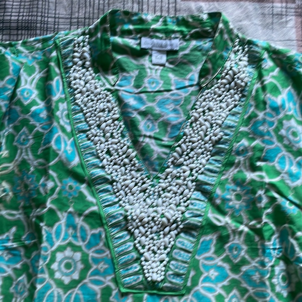 It is small for me. Petite printed V-neck top for women. Beautiful green print.